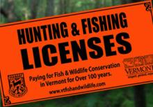 A blaze orange hunting and fishing license sign