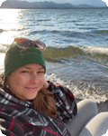 image of woman next to lake shore with waves