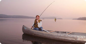 girl fishing from a canoe