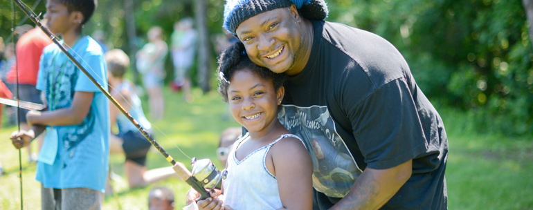 Father and daughter fishing at fishing festival