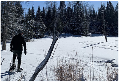 man snowshoeing