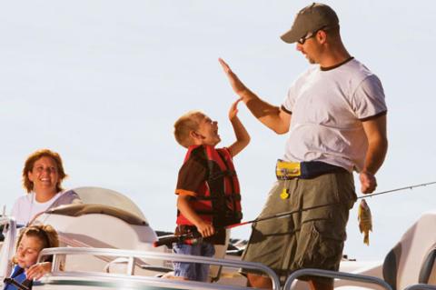 father and son celebrating a catch