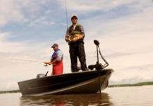 two guys fishing from a boat