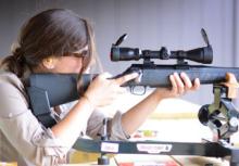 woman taking aim